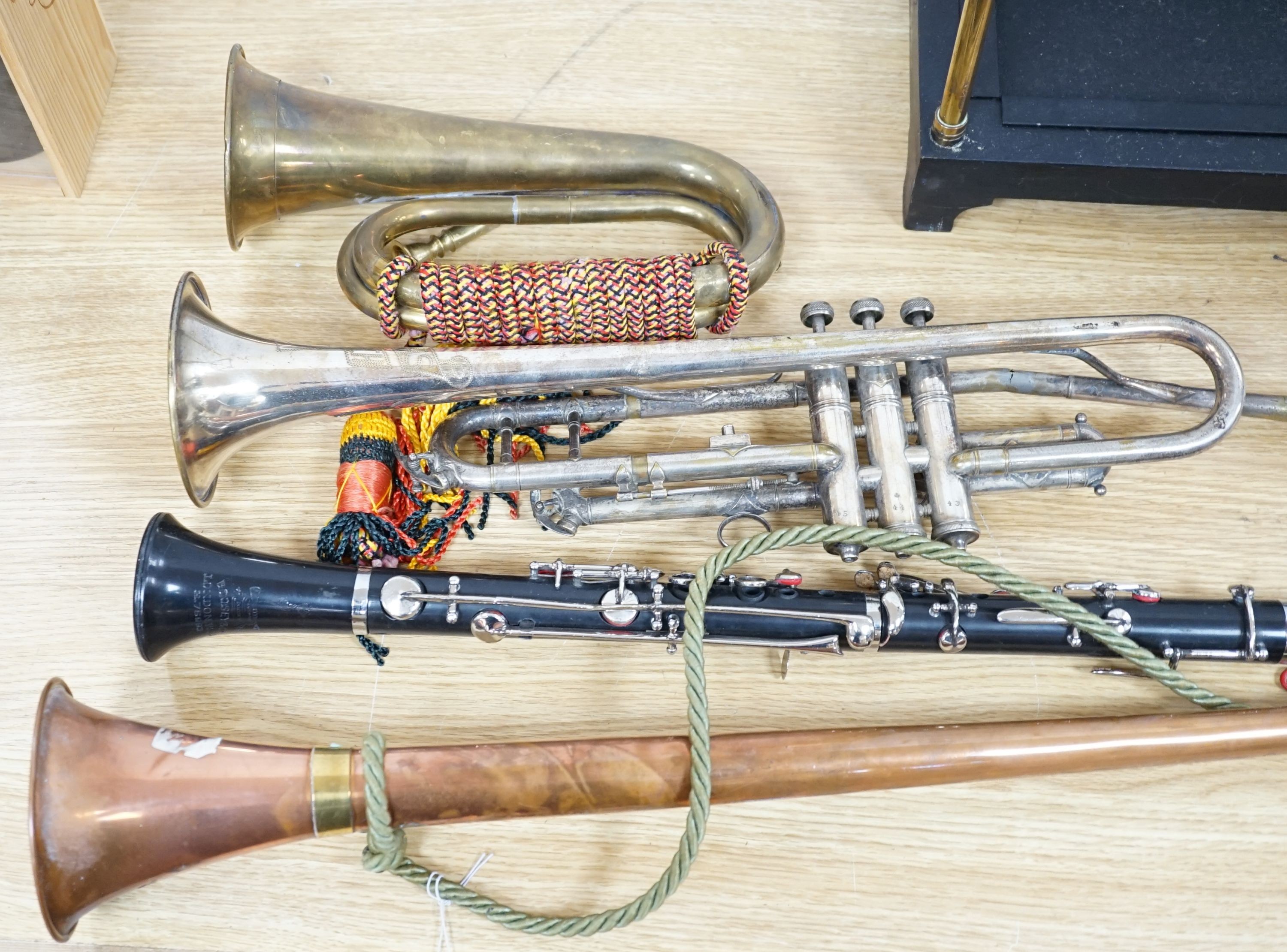 A Boosey and co Clarinet H.75983, plated trumpet, brass bugle and a copper hunting horn 87cm